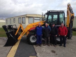 Brian Frizzell (right) handing over Terex 890 Backhoe – 55 Anniversary edition to Freddie Chestnutt, Raymond Newell & Ossy McCall from Chestnutt Holiday Park.