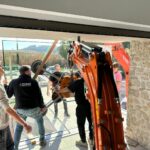 Develon Mini-Excavator Used to Install Panes of Glass -2